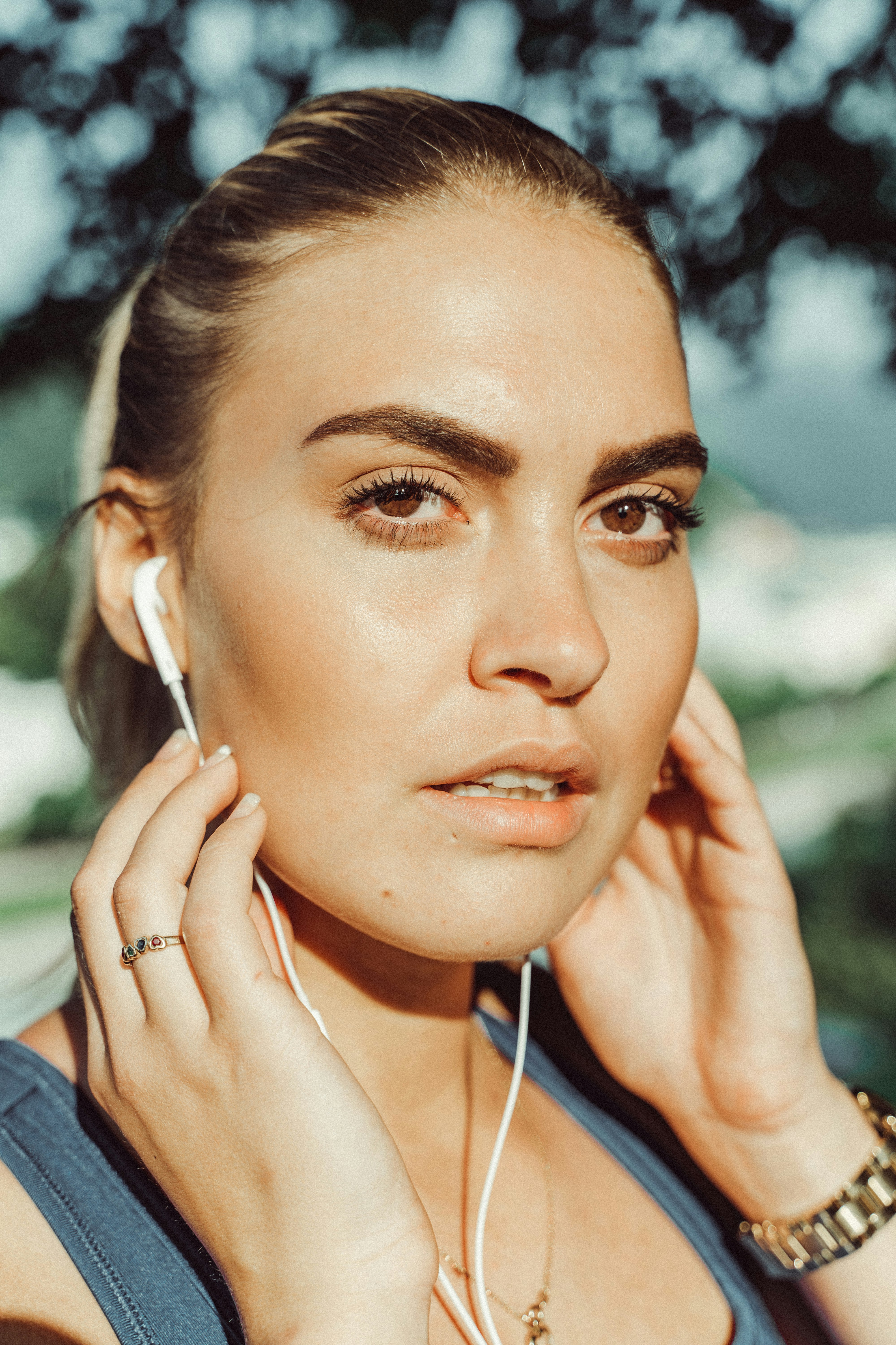 woman in black leather jacket with white earbuds